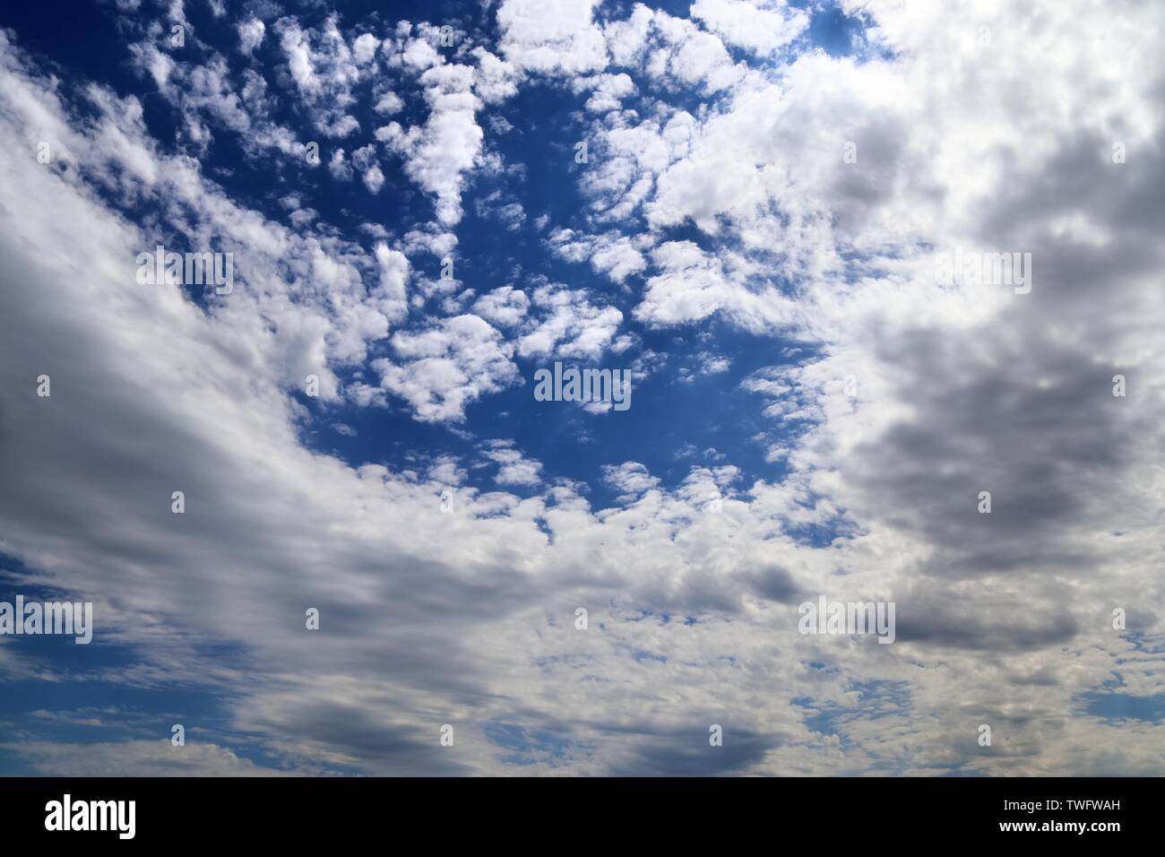 Beautiful white fluffy cloud formations on a deep blue sk Stock Photo