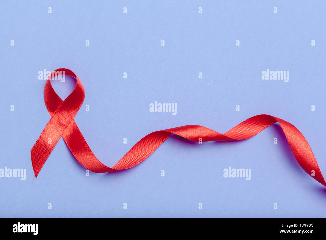 ribbon HIV, AIDS on blue background Stock Photo - Alamy
