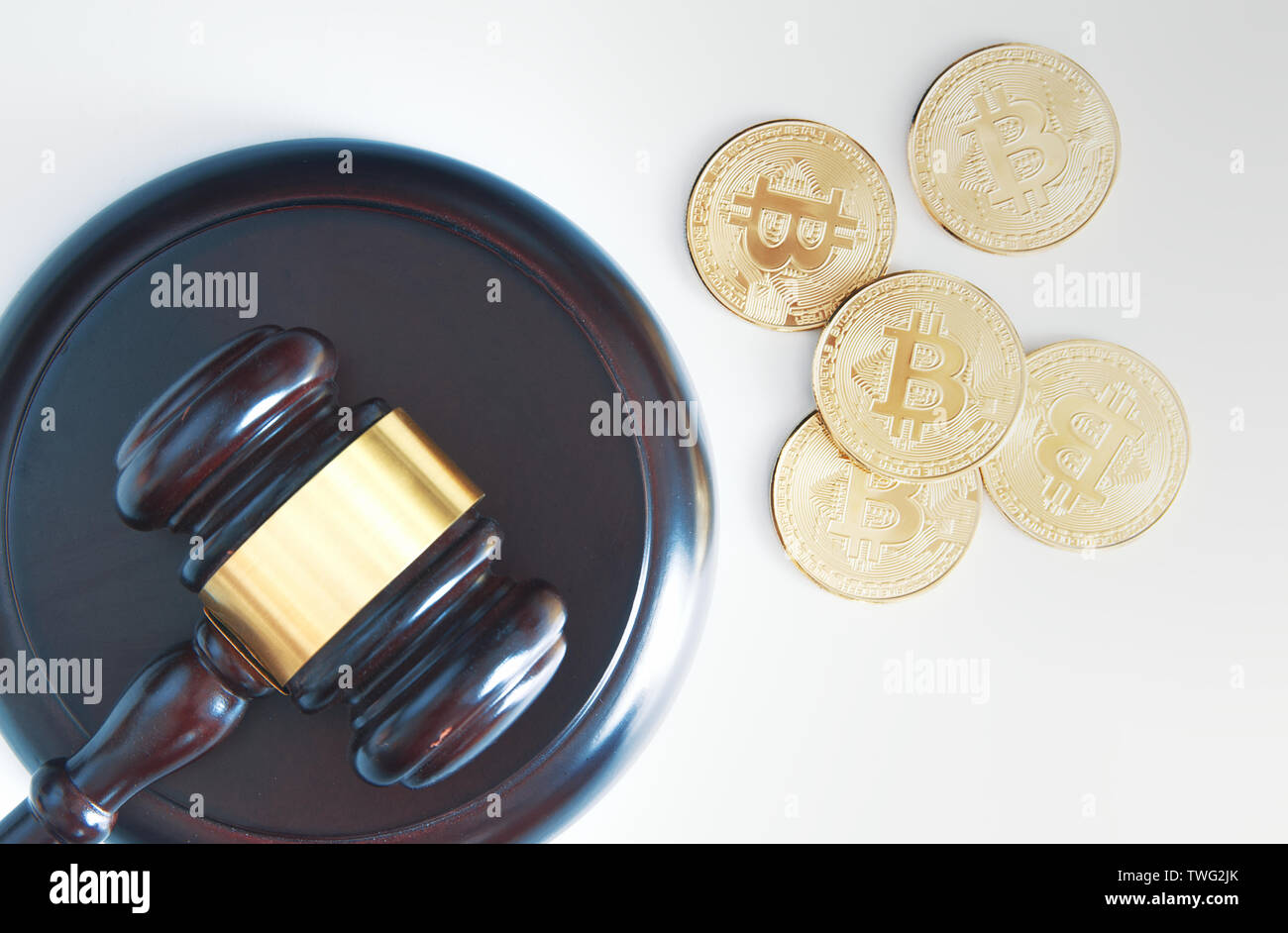 Judge mace next to some bitcoin currency coins from above. Top down view and legislation concept. Stock Photo