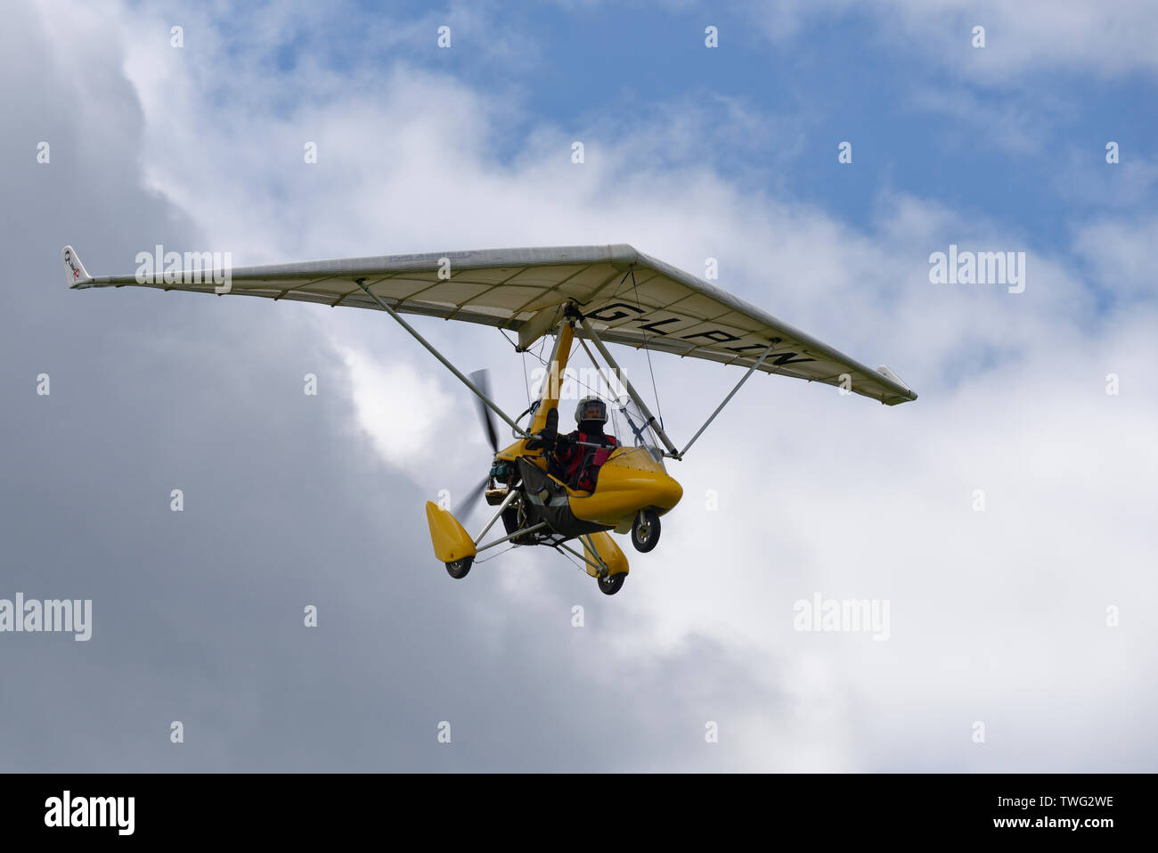 Smart looking yellow QuikR flex wing microlight aircraft flying above Popham Airfield near Basingstoke Hampshire Stock Photo