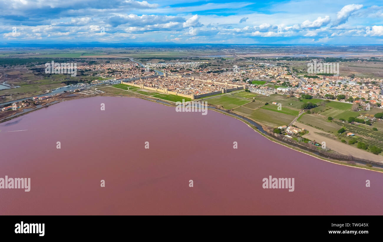 Aerial view on the pink salt lake and Aigues-Mortes - medieval fortified town in South France. Stock Photo