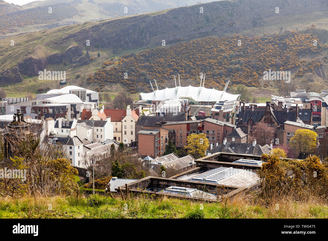 Elevated view of part of Edinburgh, Dynamic earth, Scottish Parliament, old and new architecture in the Canongate and Salisbury Crags. Scotland, UK Stock Photo