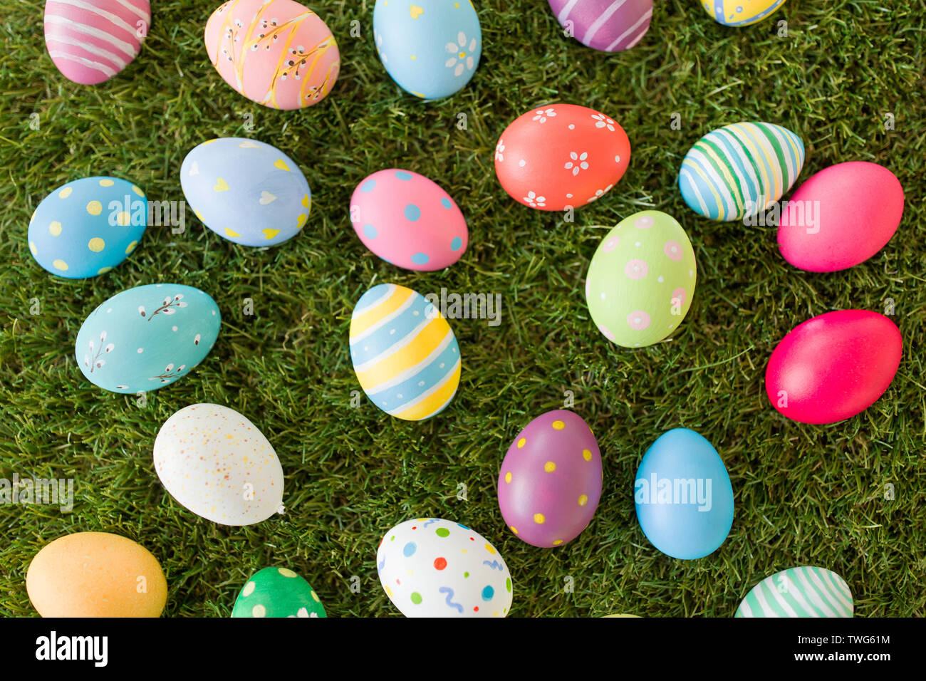 colored easter eggs on artificial grass Stock Photo