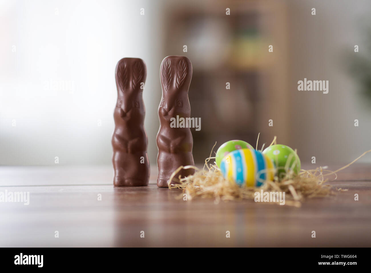 easter eggs in straw nest and chocolate bunnies Stock Photo - Alamy
