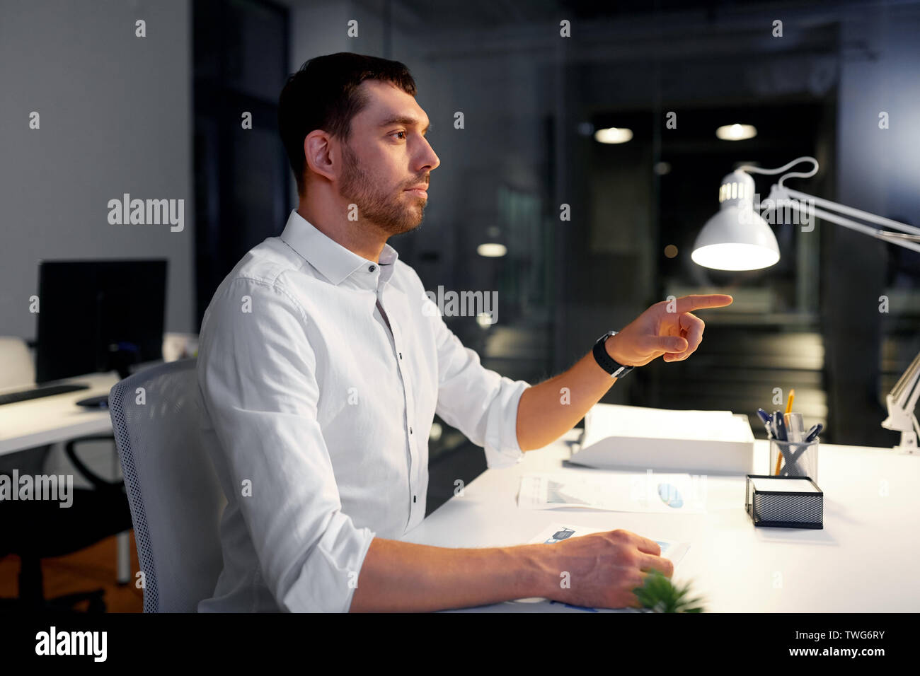 businessman using gestures at night office Stock Photo