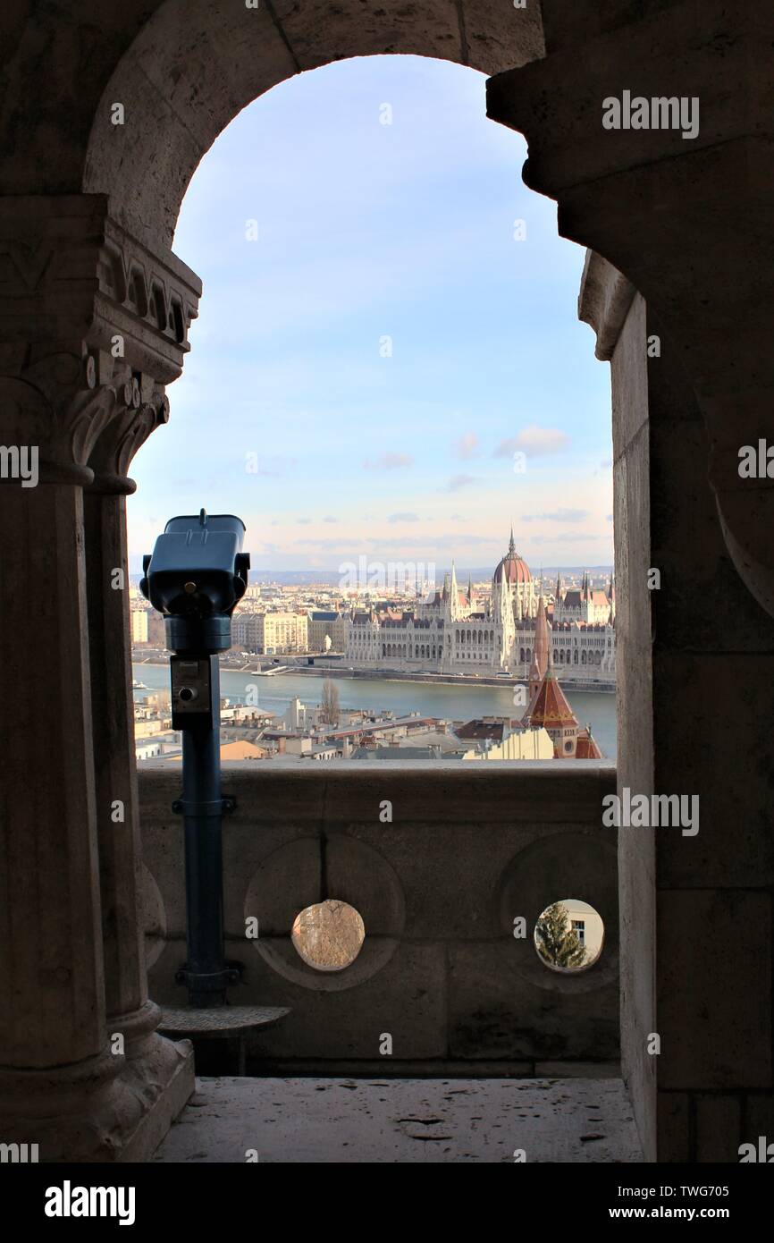 View through an archway at Fisherman's Bastion, on the Buda side of Budapest, of the river Danube, House of Parliament and the Pest side of the city. Stock Photo