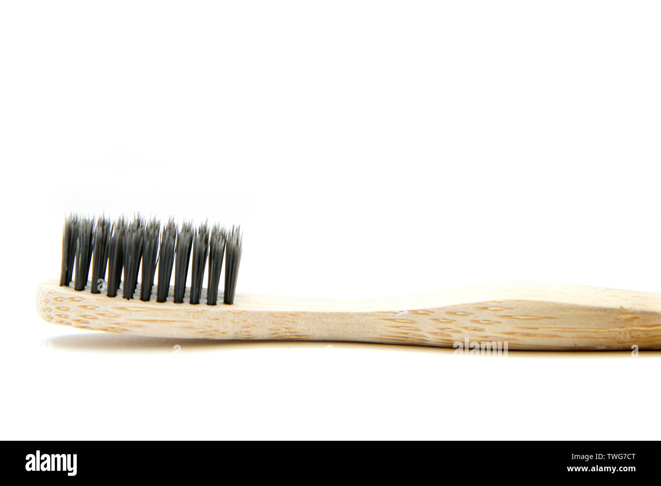 A toothbrush from natural materials. Made from bamboo wood. Isolated on a white background. Stock Photo