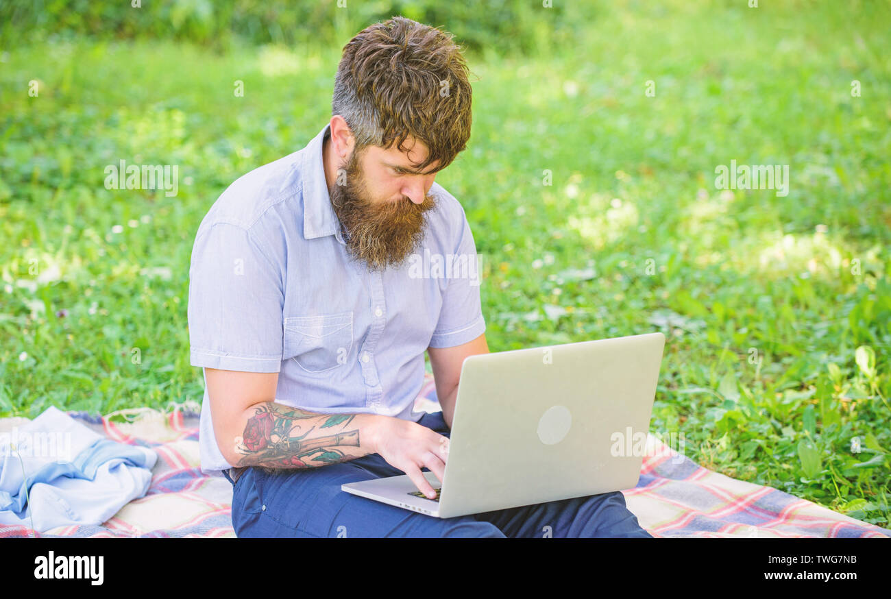 Man bearded with laptop sit meadow nature background. Blogger becoming inspired by nature. Writer looking for inspiration nature environment. Inspiration for blogging. Looking for inspiration. Stock Photo