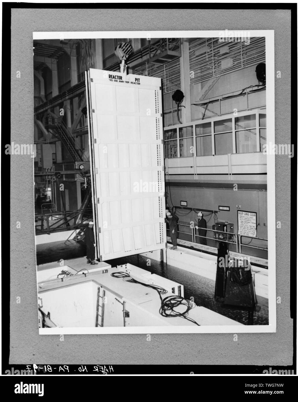 REACTOR PIT CANAL GATE INSTALLATION, FEBRUARY 15, 1960 - Shippingport Atomic Power Station, On Ohio River, 25 miles Northwest of Pittsburgh, Shippingport, Beaver County, PA; Rickover, Hyman G; Duquesne Light Company; U.S. Department of Energy; Atomic Energy Commission; Westinghouse Electric Corporation; Bettis Atomic Power Laboratory; Stone and Webster Engineering Corporation; Dravo Corporation; Simpson, John W; Gray, John E; Barker, Joseph H; Iselin, Donald G; Combustion Engineering, Incorporated; Knolls Atomic Power Laboratory; Clark, Philip R; Leighton, David T; Mealia, John E; Raab, Harry Stock Photo