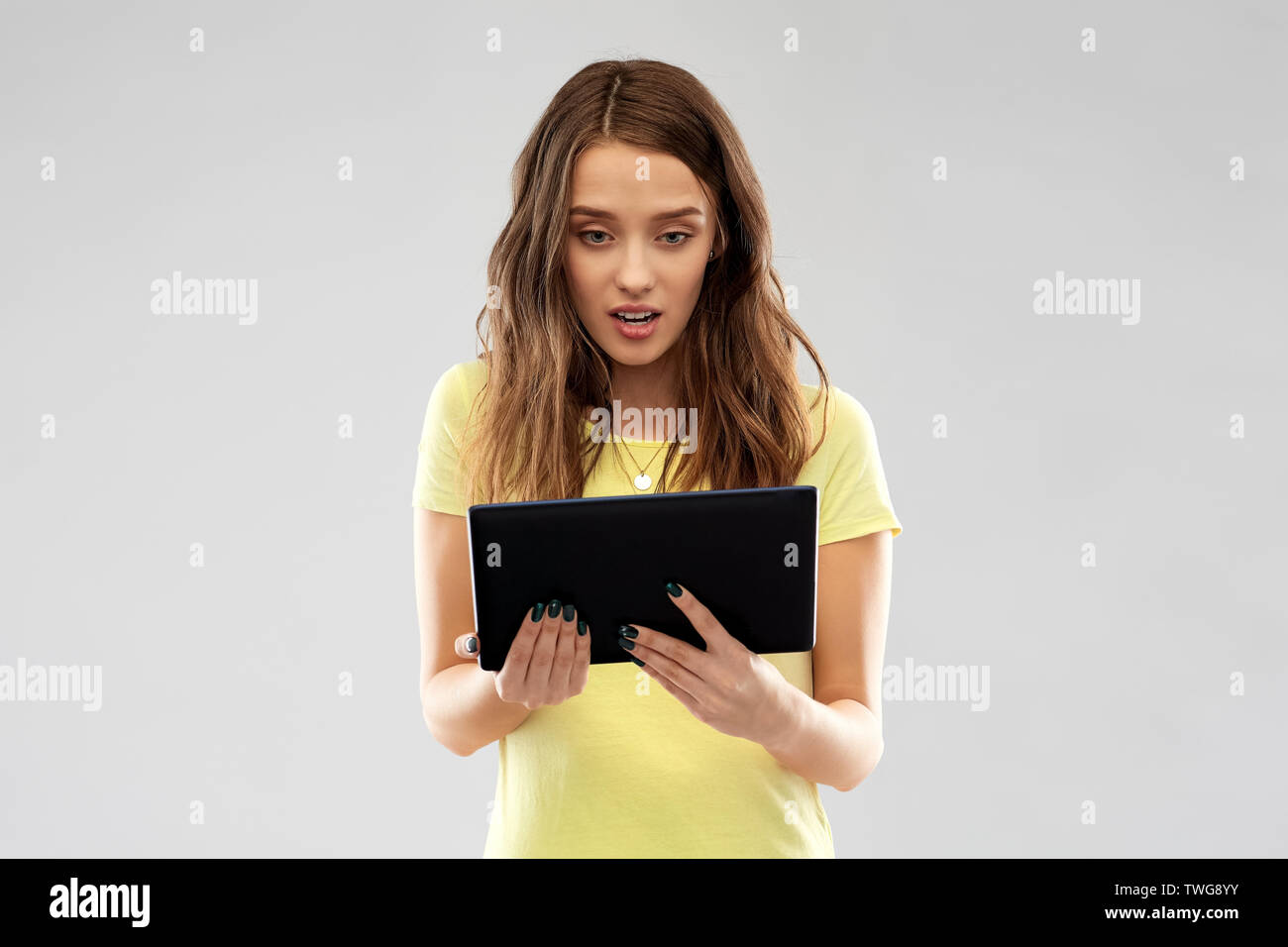 young woman or teenage girl using tablet computer Stock Photo