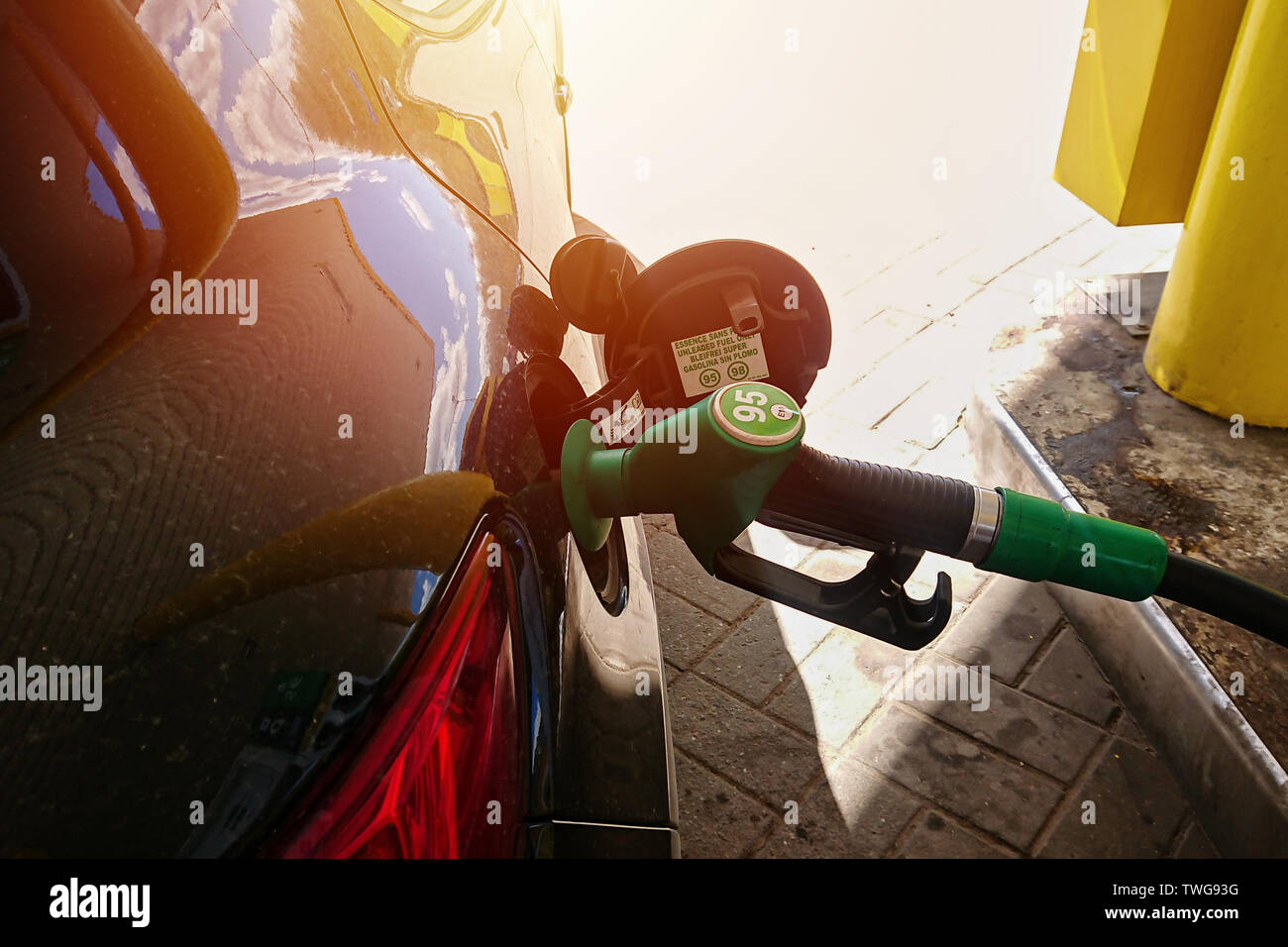 Close Up of gasoline fuel pump nozzle in a car fuel tank. Concept of