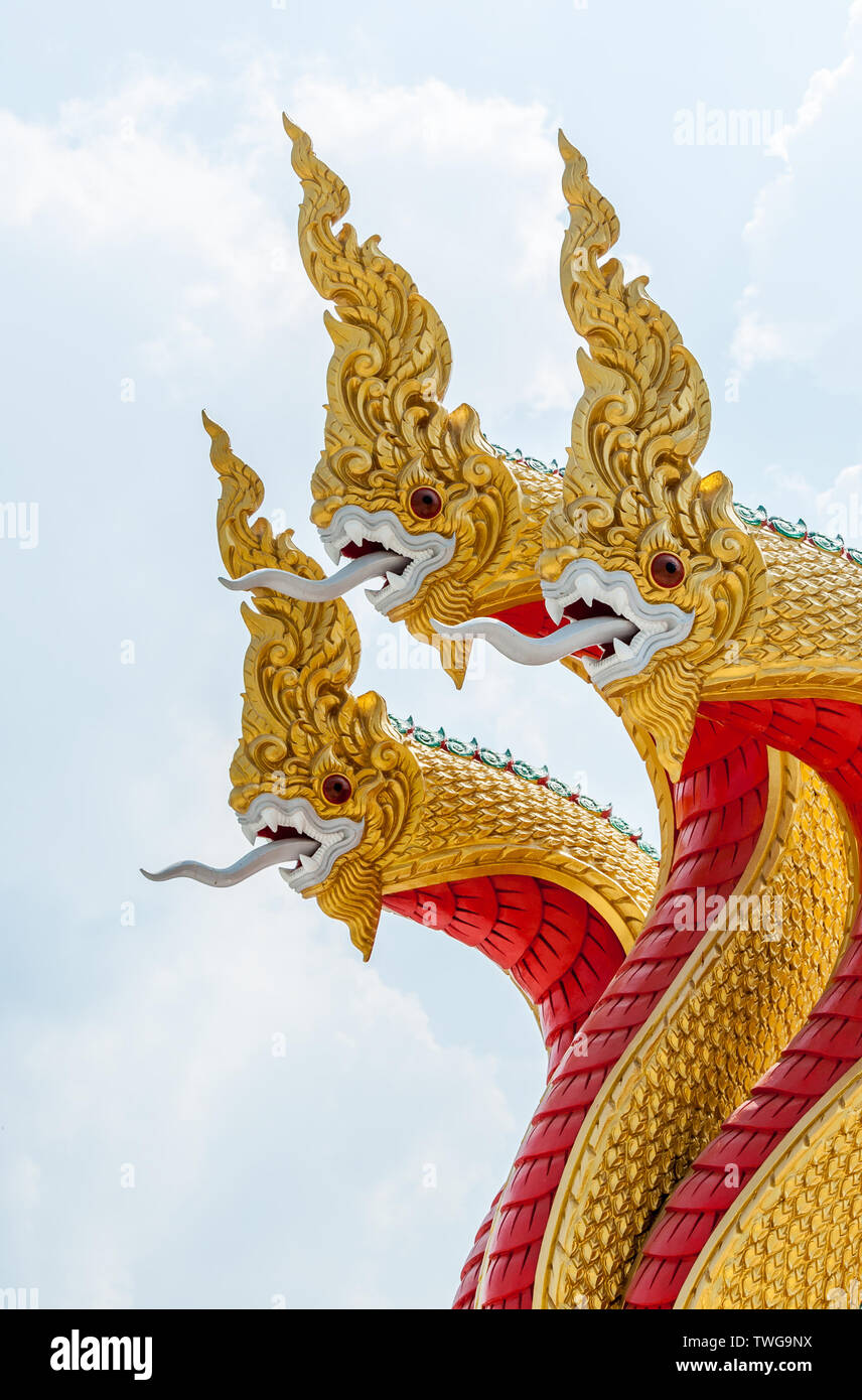 Golden serpent sculpture in the traditional Thai style under the blue sky,Thai temple.(Public