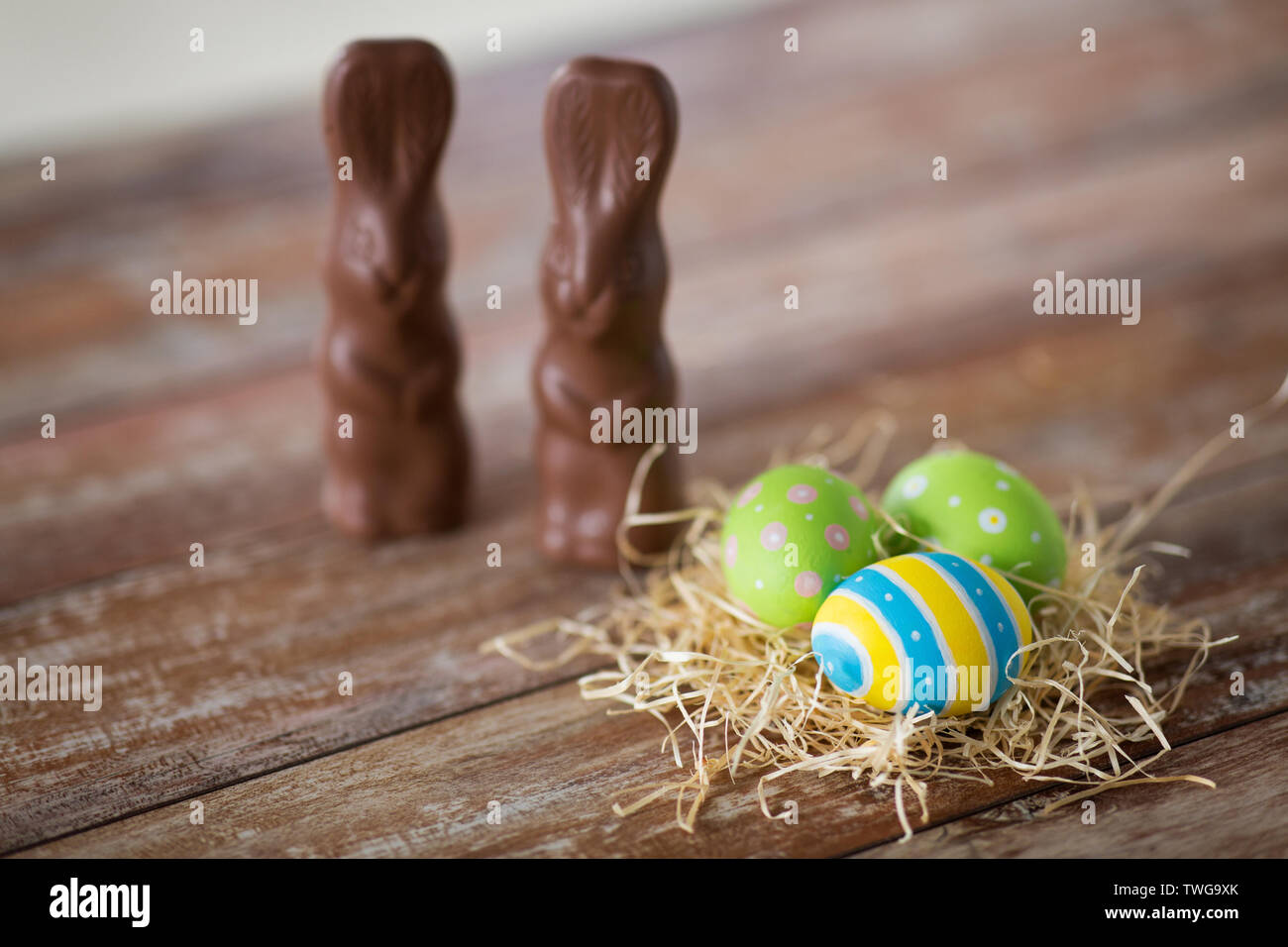 easter eggs in straw nest and chocolate bunnies Stock Photo - Alamy