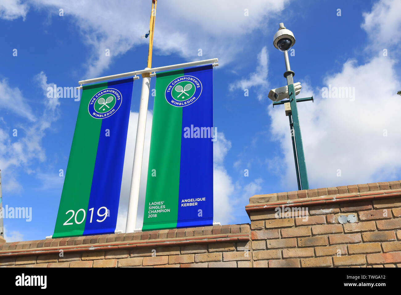 London, UK. 20th June, 2019. Banner with the name of the Angelique Kerber 2018 Wimbledon Ladies' champion hangs above the gates of the (AELTC) All England Lawn and Tennis Club which prepares to host the 2019 Wimbledon Championships. Credit: Amer Ghazzal/SOPA Images/ZUMA Wire/Alamy Live News Stock Photo