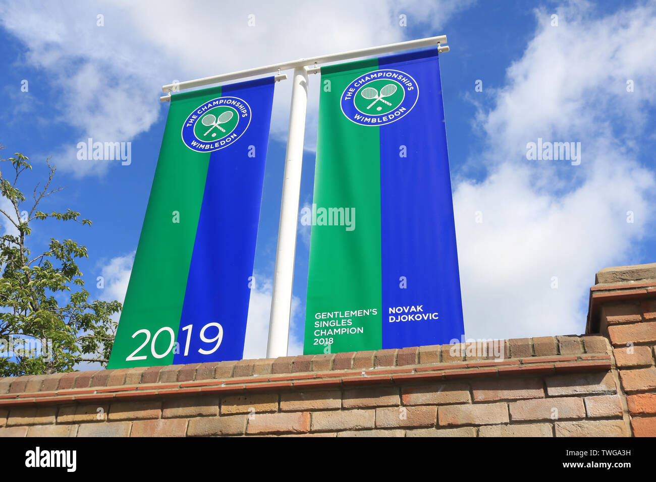 London, UK. 20th June, 2019. Banners with the name of the Novak Djokovic 2018 Wimbledon Mens' champion hangs above the gates of the (AELTC) All England Lawn and Tennis Club which prepares to host the 2019 Wimbledon Championships Credit: Amer Ghazzal/SOPA Images/ZUMA Wire/Alamy Live News Stock Photo