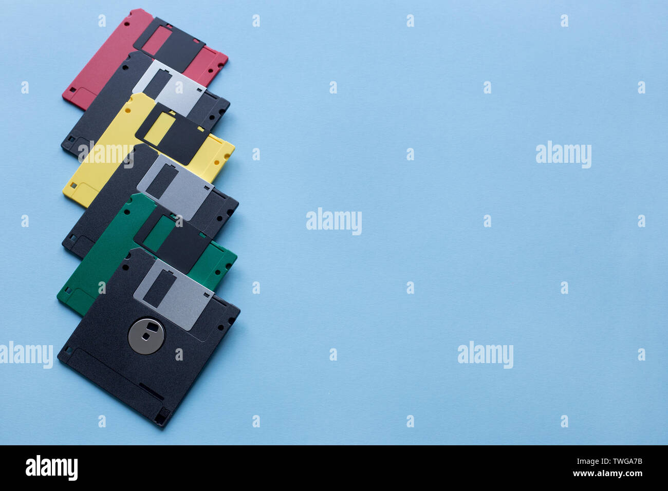Group of multi-colored flexible disks isolated on a blue background ...