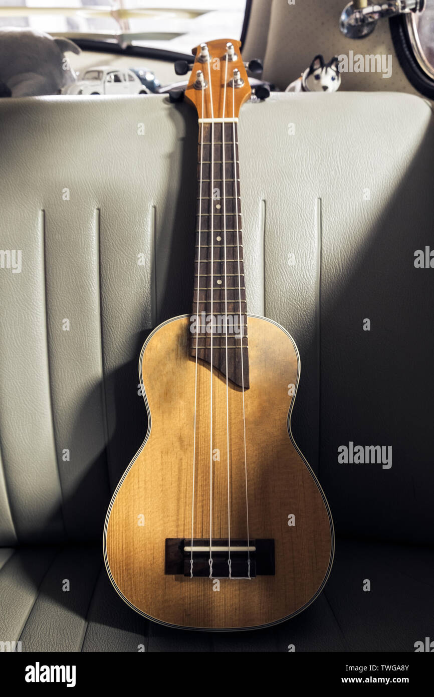 Ukulele on seat vintage car light and shadow Stock Photo Alamy