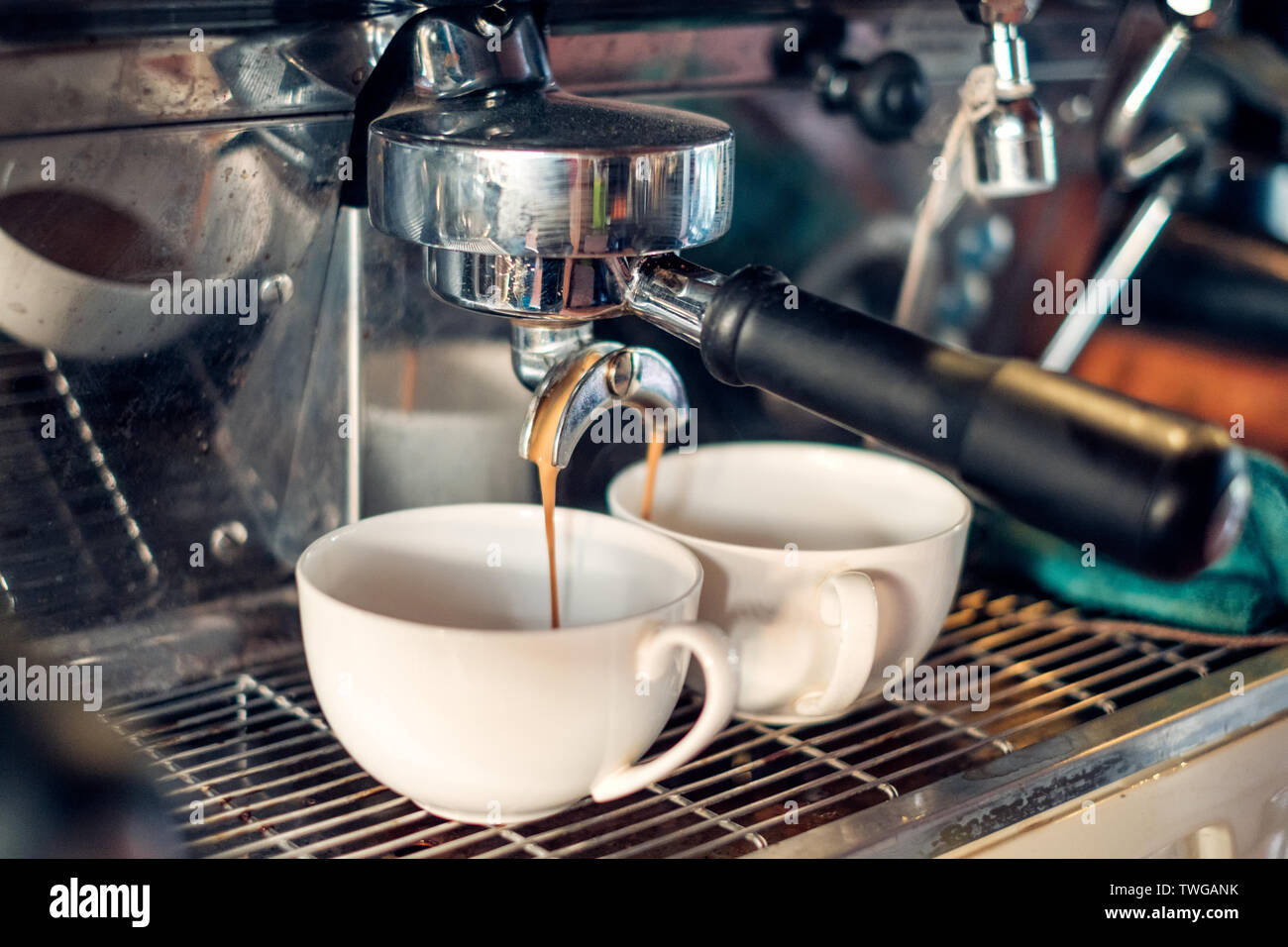 Coffee Maker making coffee flowing in two cup Stock Photo