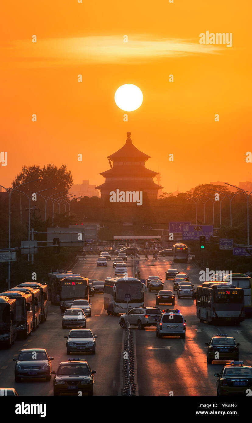 On September 20, 2016, Beijing, every year around the equinox and the autumnal equinox, the sun rises from the east to set in the west. If you catch up with a clear and good weather, you can clearly see the slow fall of a round of sun in the west on the road east and west of Beijing. Stock Photo