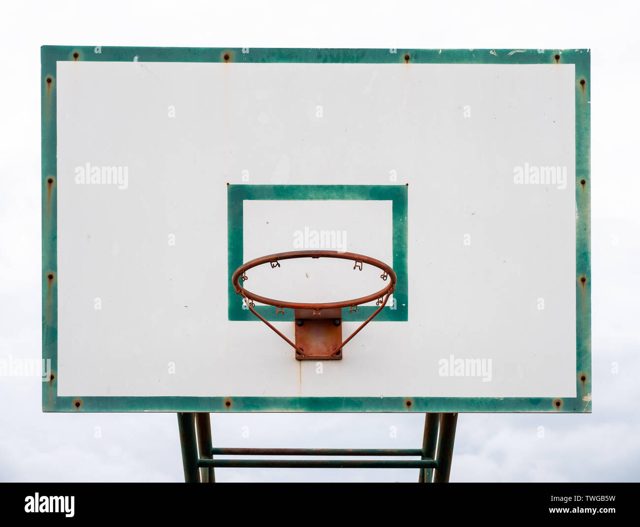 Wood basketball backboard with hoop green frame and aged weathered Stock Photo
