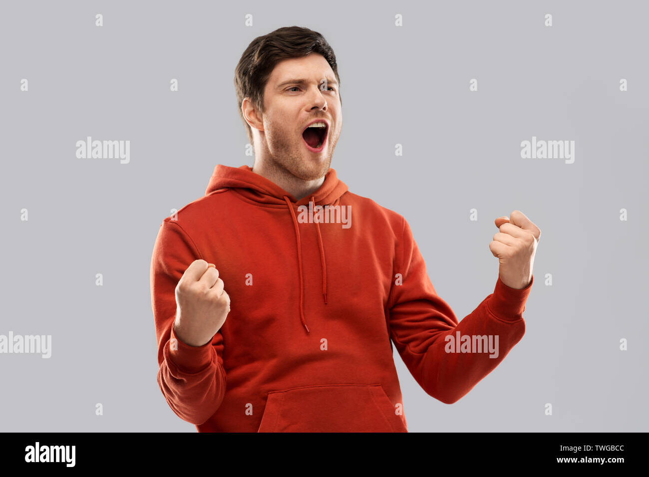happy man celebrating and making fist pump gesture Stock Photo Alamy