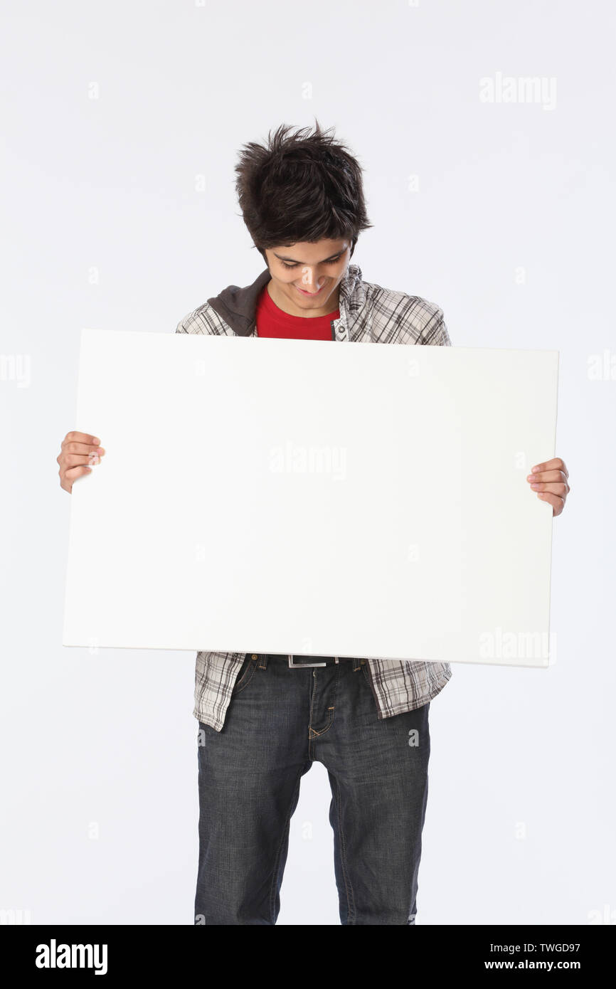 Teenage boy holding an empty placard Stock Photo - Alamy