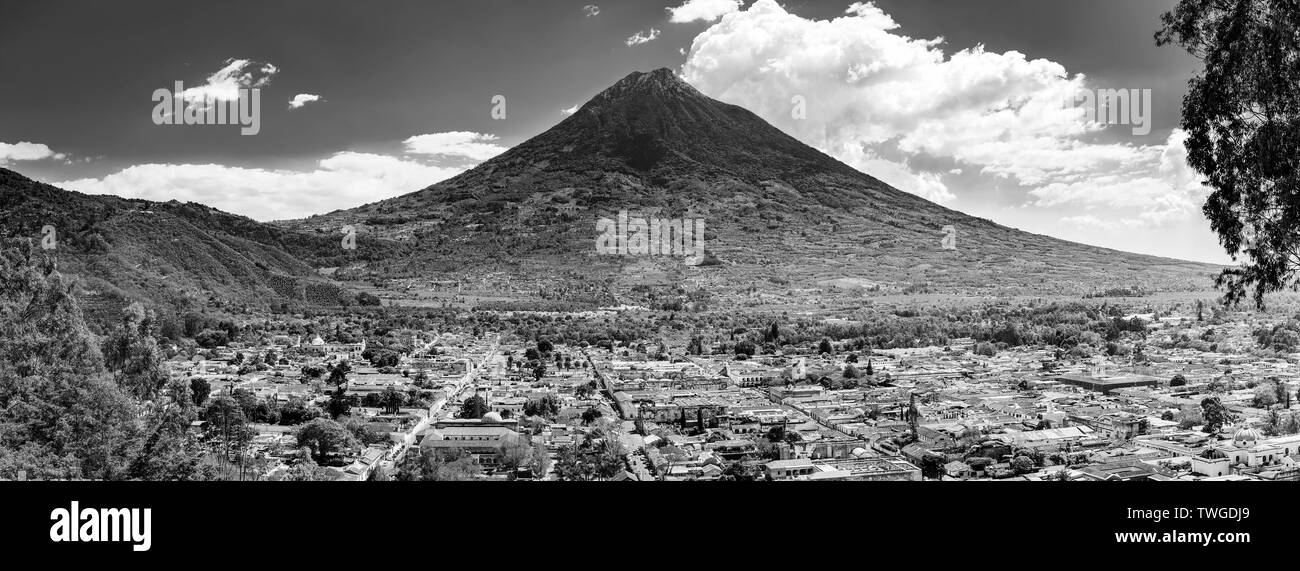 View of the city of Antigua, Guatemala with Volcan de Agua behind in Central America in stunning black and white Stock Photo