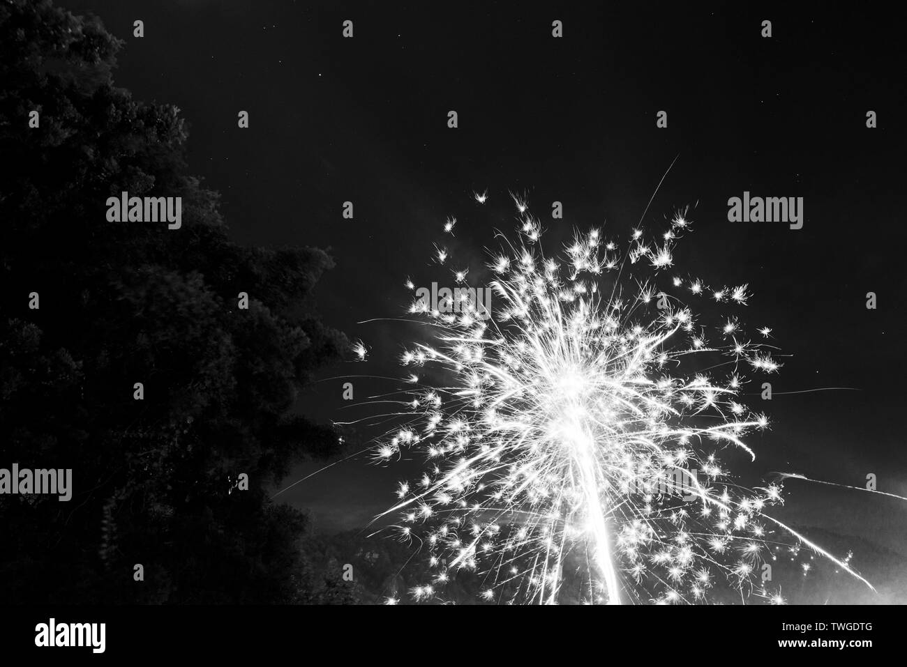 Fireworks light up the night sky on New Years Eve in Guatemala in stunning black and white Stock Photo