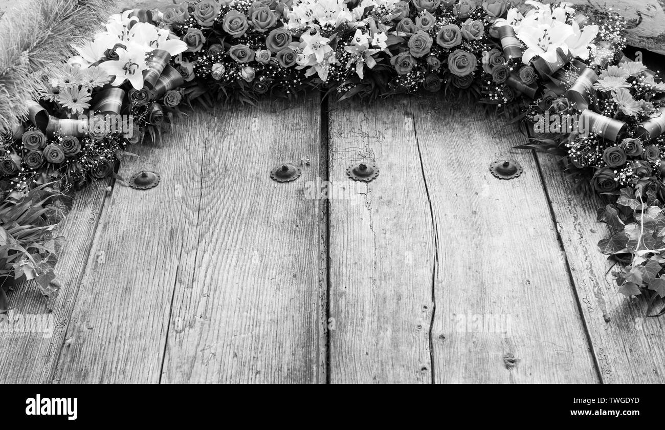 Floral arrangement on old wood with copy space in stunning black and white Stock Photo