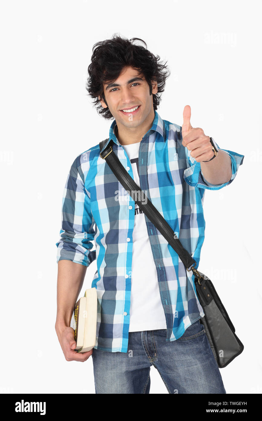 College student showing thumbs up sign and smiling Stock Photo - Alamy
