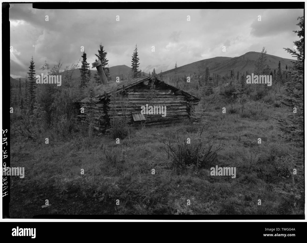 REAR WALL, LOOKING SOUTH, SHOWING HATCH FOR FIREWOOD. - A. D. Wilcox Drift Mine, Boiler Cabin, Linda Creek near Dalton Highway, Bettles, Yukon-Koyukuk Census Area, AK Stock Photo