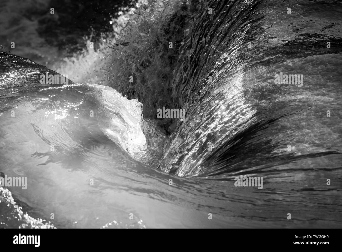 Natural waterfall whirlpool as tranquil background in stunning black and white Stock Photo