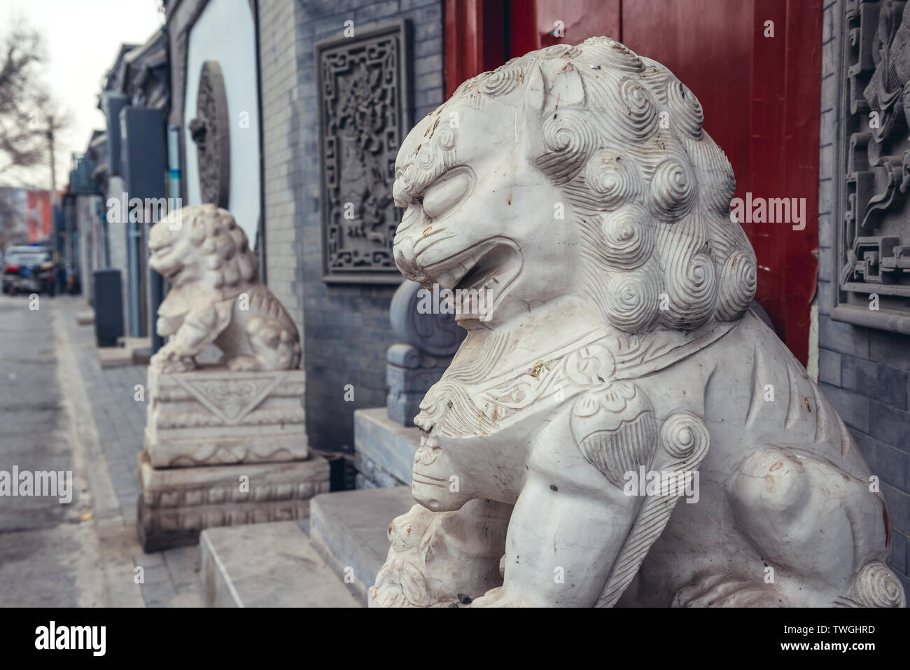 Lion statues in traditional hutong residential area in Dongcheng district of Beijing, China