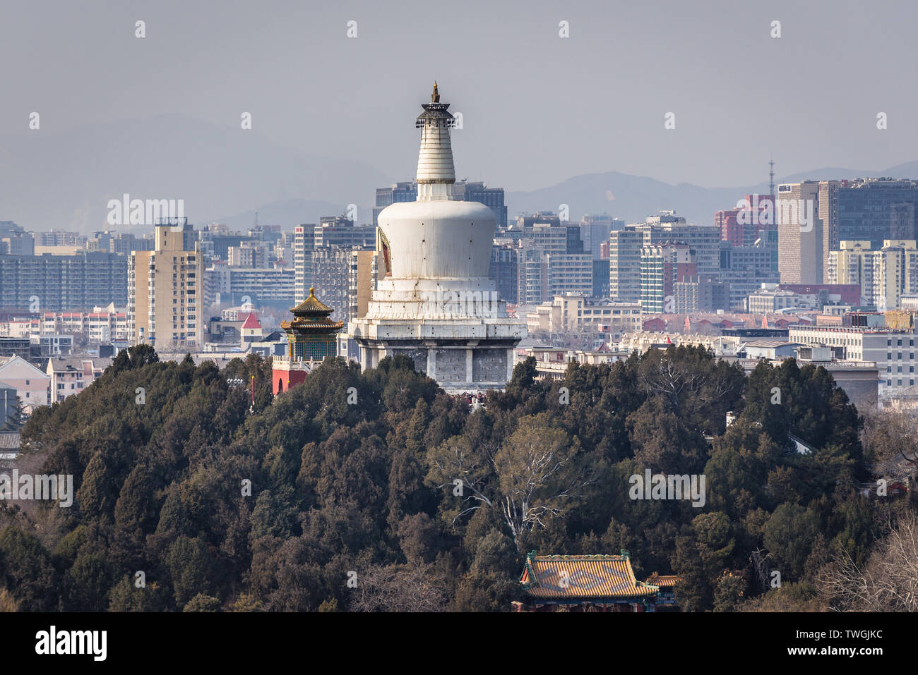 White Dagoba on Jade Flower Island in Beihai Park seen from Pavilion of Everlasting Spring Pavilion in Jingshan Park in Beijing, China Stock Photo