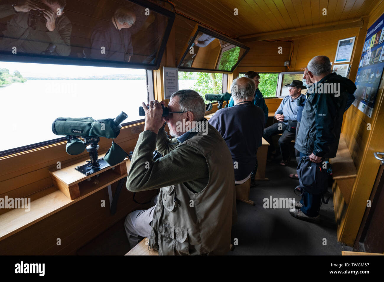 Birdwatchers inside Osprey birdwatching hide at Scottish Wildlife Trust visitor centre at Loch of the Lowes, near Dunkeld in Perthshire, Scotland, UK Stock Photo