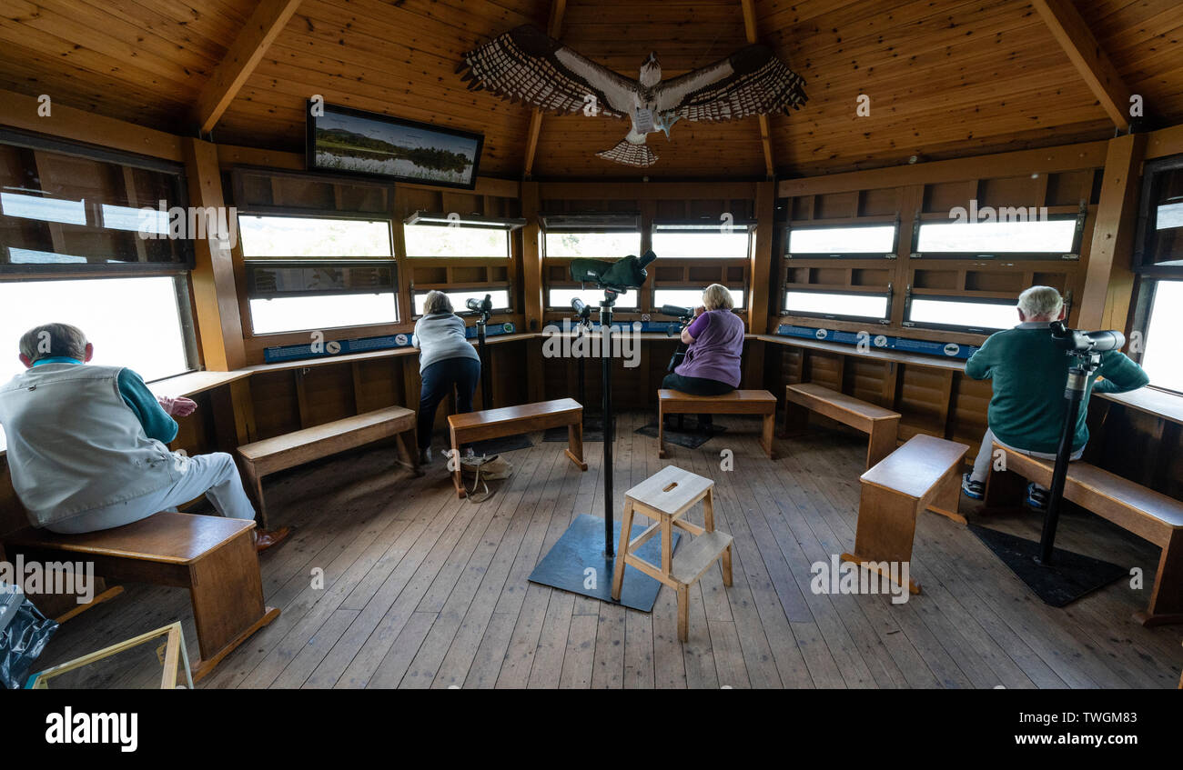 Birdwatchers inside Osprey birdwatching hide at Scottish Wildlife Trust visitor centre at Loch of the Lowes, near Dunkeld in Perthshire, Scotland, UK Stock Photo