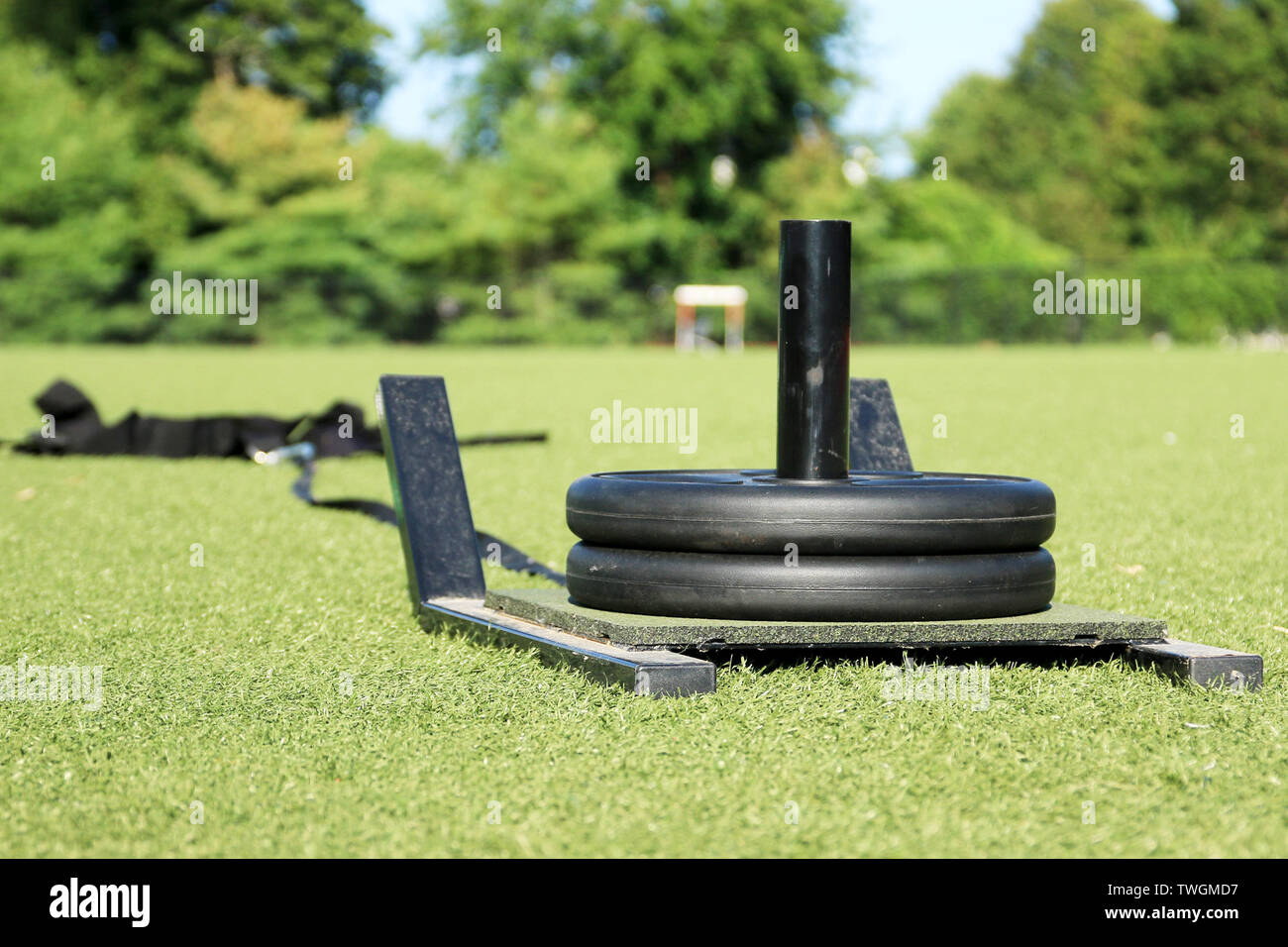 A sled that athletes pull for speed training with weights on it, on a