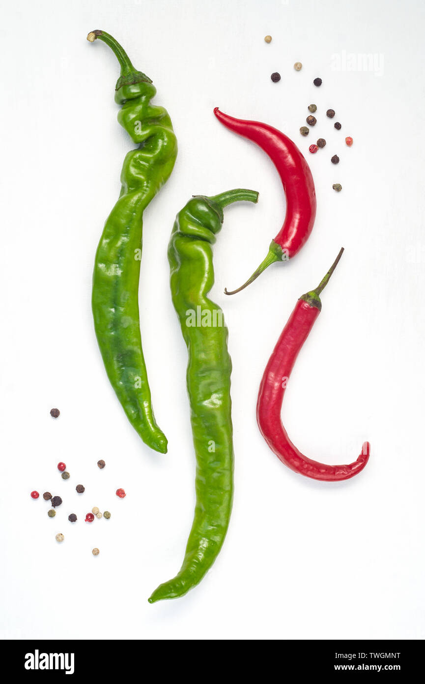 Pods of green and red chili peppers on a white background Stock Photo ...