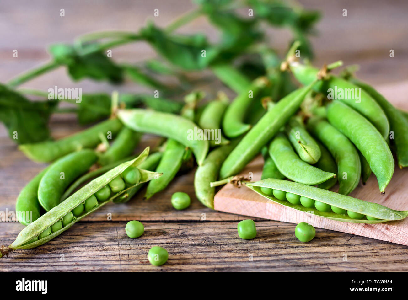 Fresh peas on wooden board . Selective focus. Stock Photo