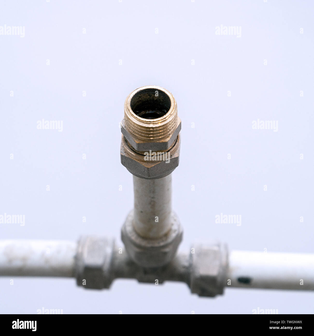 Old connection fitting tee on plastic pipes Stock Photo