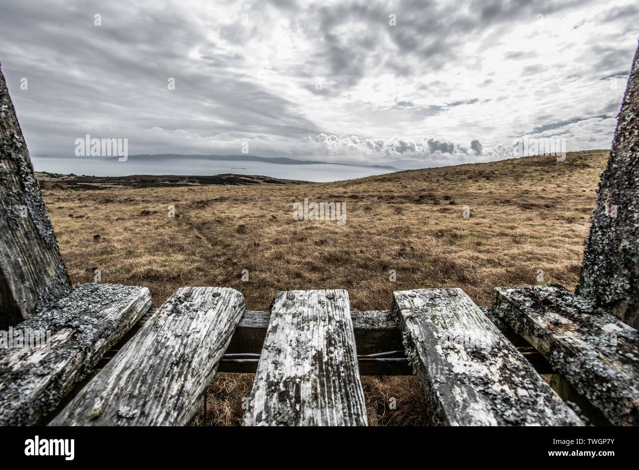 View over a stile across the Sound of Jura towards Kintyre peninsula, from northern Jura and the road to Barnhill and Corryvreckan Stock Photo