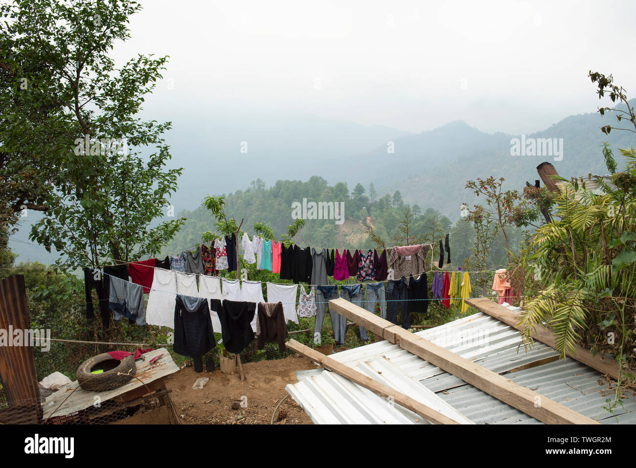 Clothes are drying on the ropes in scenic nature settings. Rural living in the mountain village of San José del Pacífico, Oaxaca, Mexico. May 2019 Stock Photo