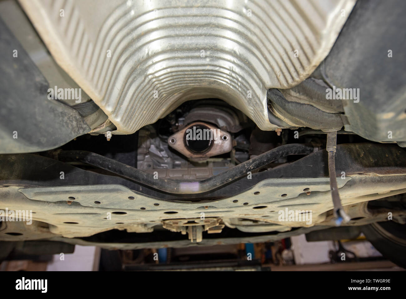 Toyota Prius Hybrid 2010. Theives have stolen the Catalytic Converter exhaust system from underneath the vehicle. Image from mechanics inspection pit. Stock Photo