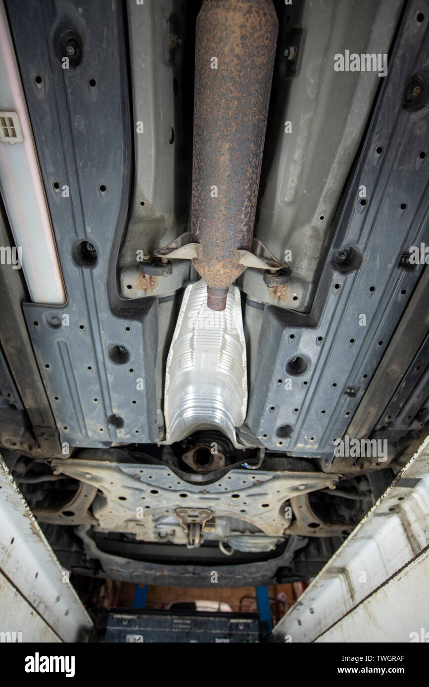 Toyota Prius Hybrid 2010. Theives have stolen the Catalytic Converter exhaust system from underneath the vehicle. Image from mechanics inspection pit. Stock Photo