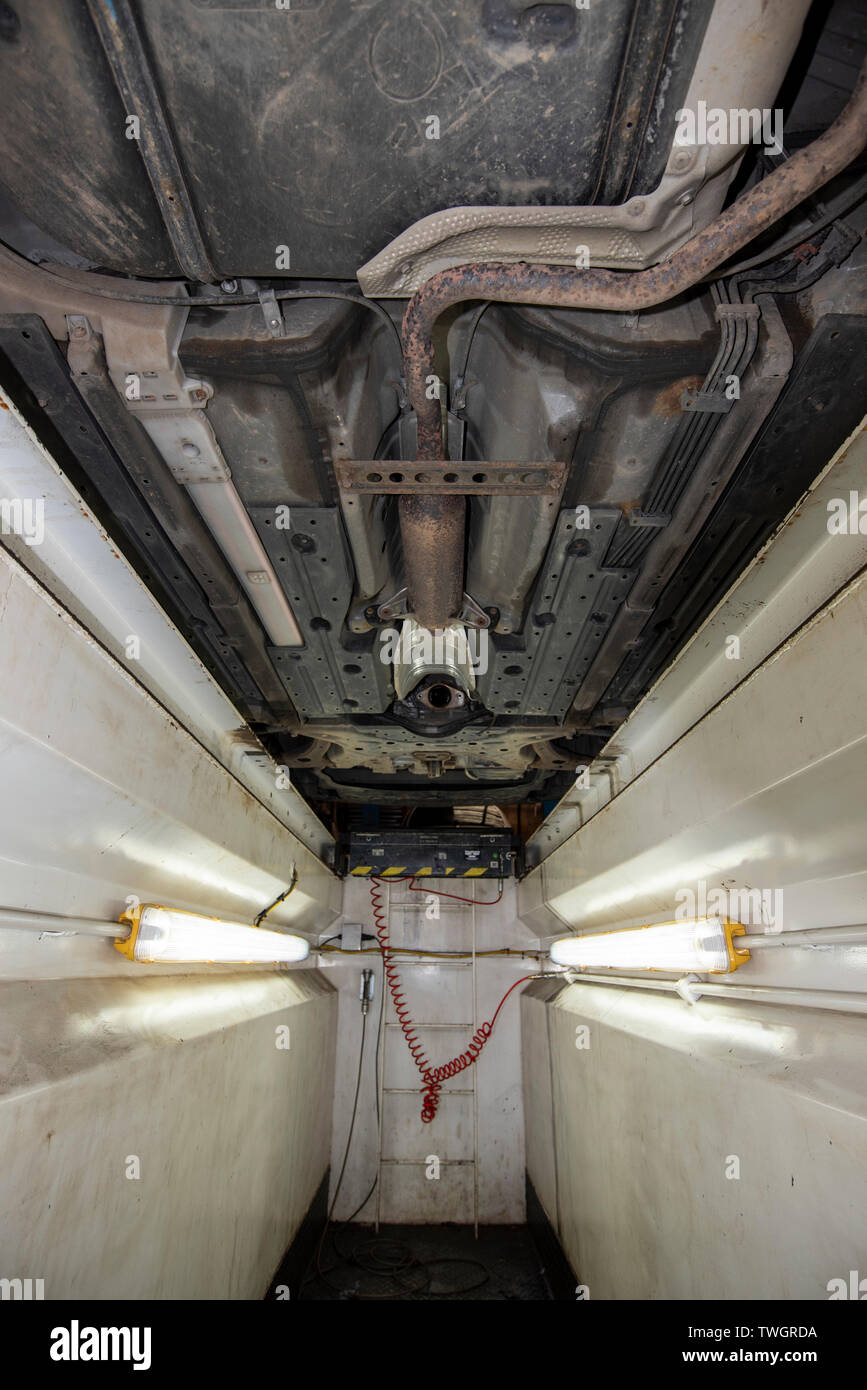 Toyota Prius Hybrid 2010. Theives have stolen the Catalytic Converter exhaust system from underneath the vehicle. Image from mechanics inspection pit. Stock Photo