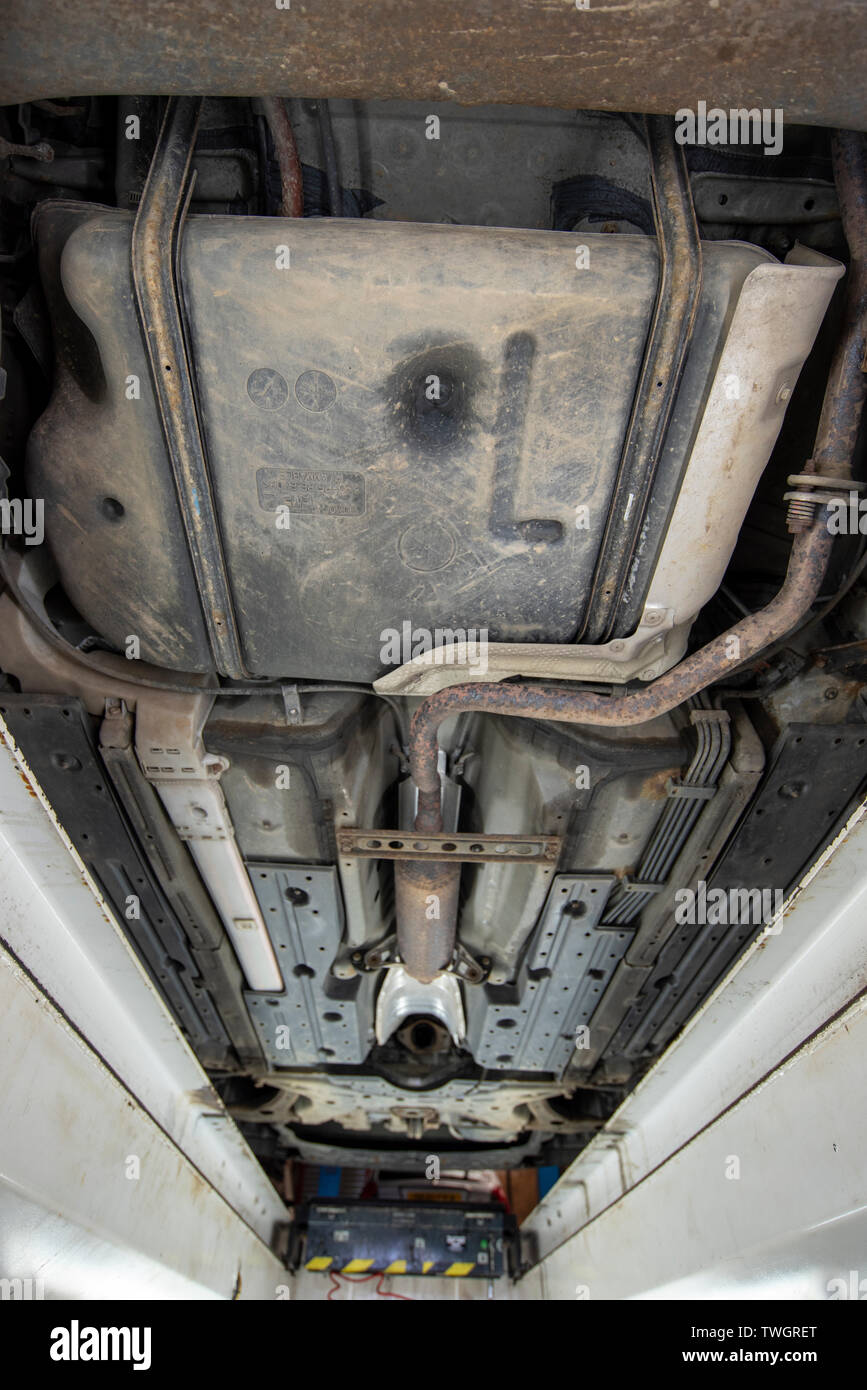 Toyota Prius Hybrid 2010. Theives have stolen the Catalytic Converter exhaust system from underneath the vehicle. Image from mechanics inspection pit. Stock Photo