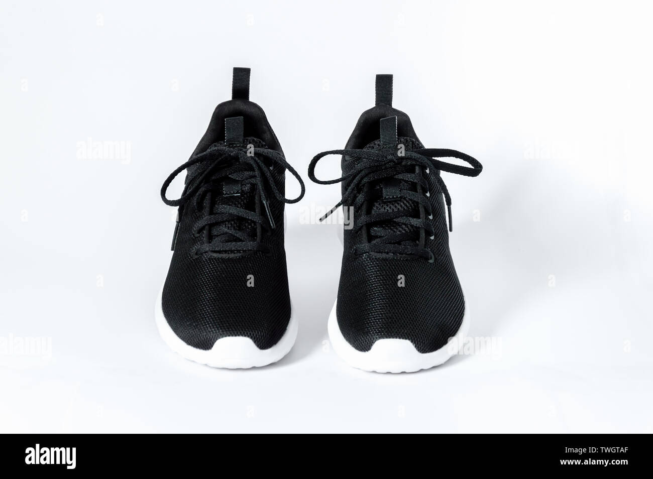 Black sports running shoes with white sole isolated on white background,  front view. Concept of fitness and healthy lifestyle Stock Photo - Alamy