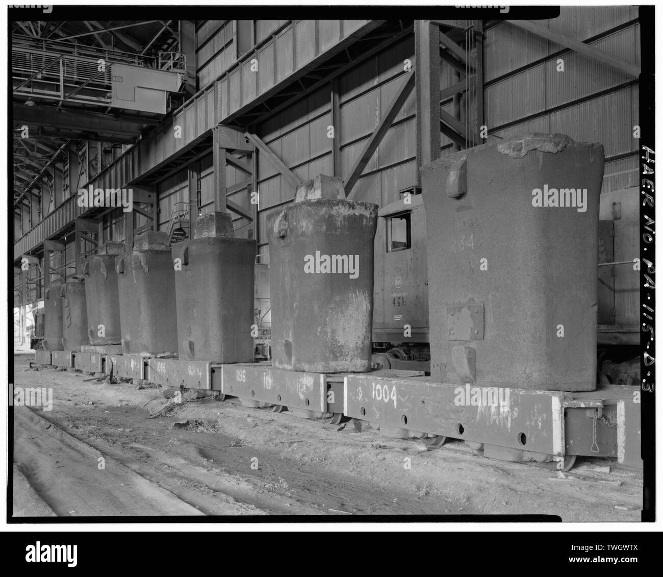 ROW OF INGOT CARS AND INGOTS IN THE PRIMARY MILL BUILDING LOOKING EAST. -  U.S. Steel Duquesne Works, Primary Mill, Along Monongahela River, Duquesne,  Allegheny County, PA; Carnegie, Andrew; Carnegie Steel Company;