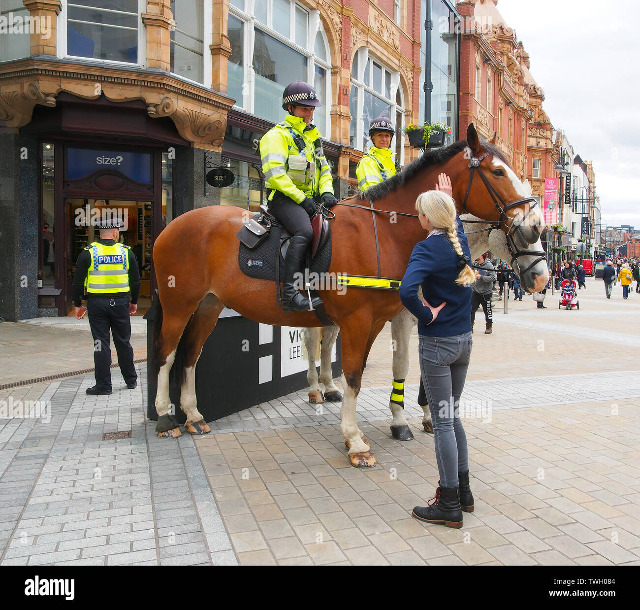Mounted police on Briggate in Leeds city centre, Yorkshire, meeting the public in a public relations PR exercise. Stock Photo