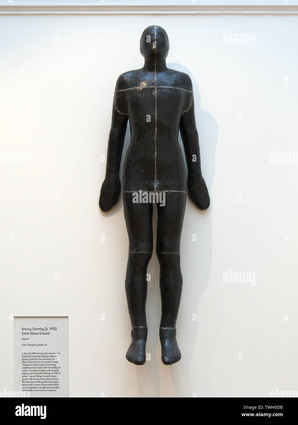 Antony Gormley statue 'Earth above Ground' hung on the wall in Leeds Art Gallery, Yorkshire, England, UK. Stock Photo